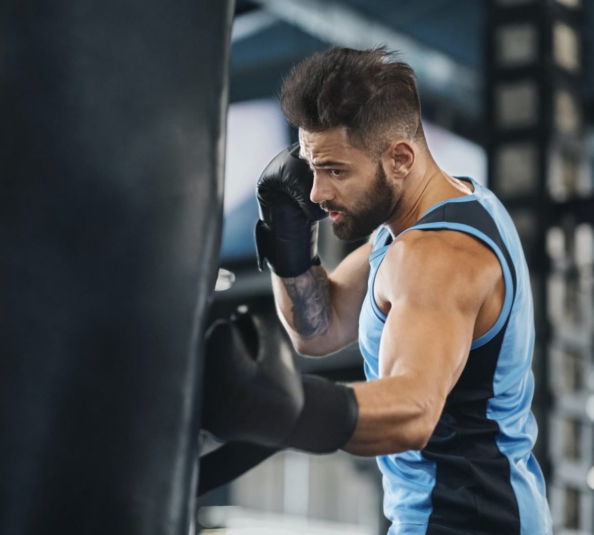 active-guy-punching-boxing-bag-at-gym.jpg